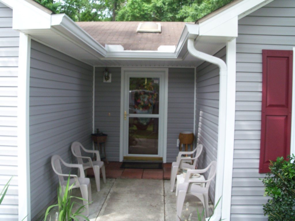 Seamless aluminum gutters on a 1980s Brunswick Georgia home near the Glynn County coast during rainy season.
