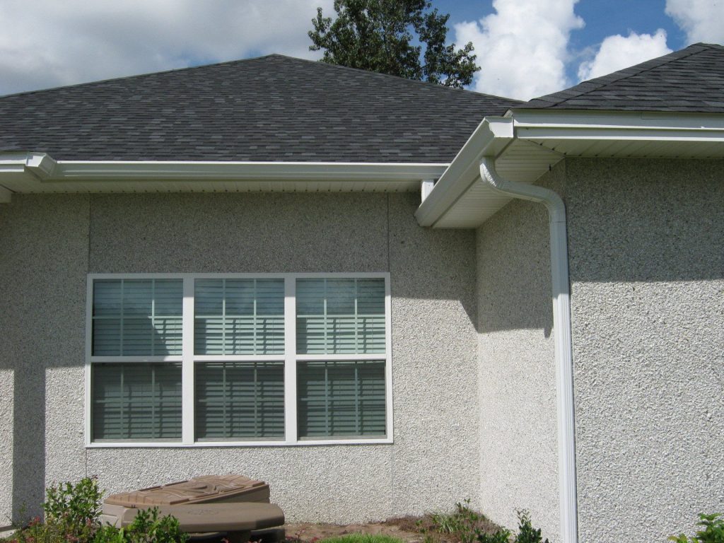 Seamless gutters directing water away from a Darien Georgia home foundation after a coastal storm.