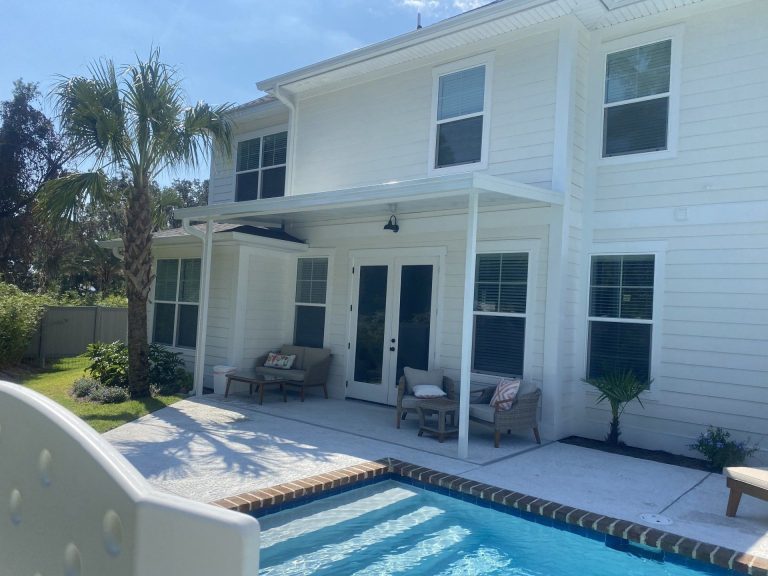 Insulated patio cover with ceiling fan installed on Jekyll Island Georgia home near the coast.