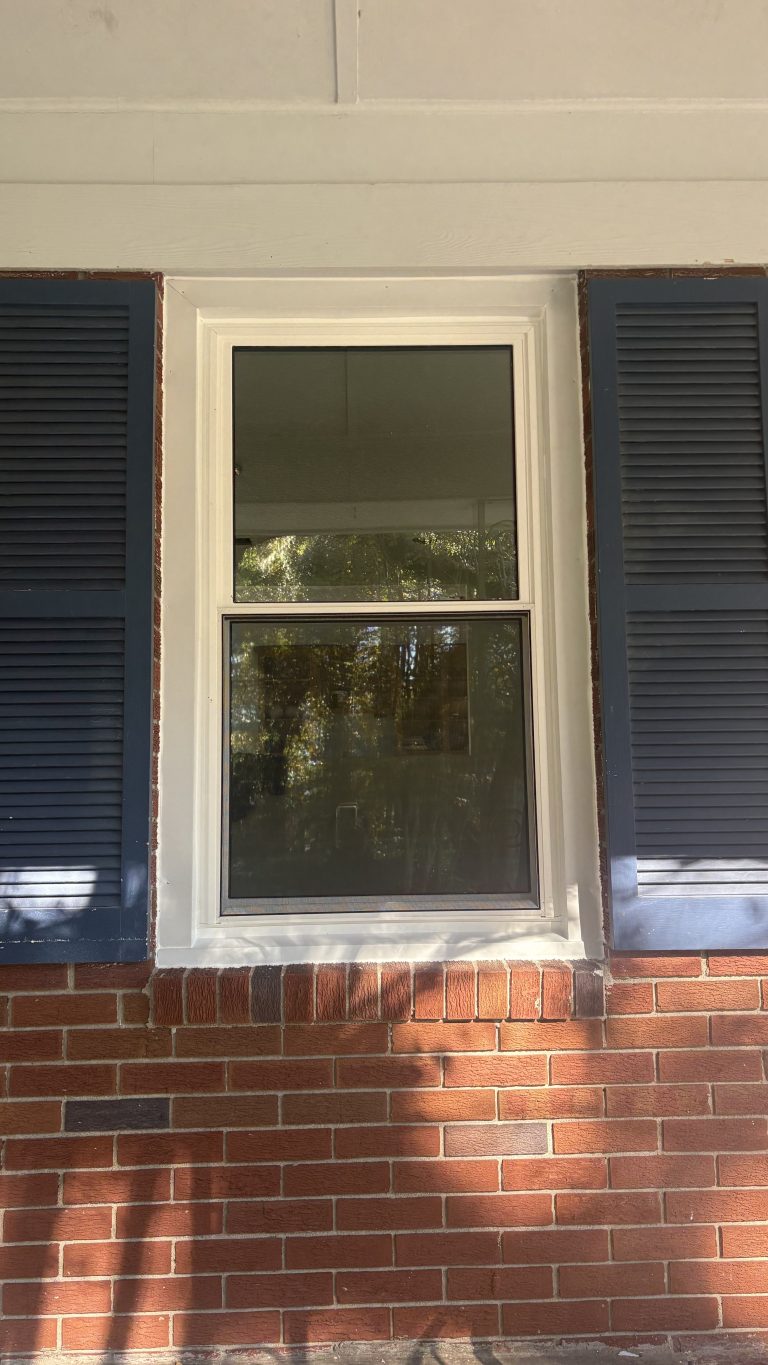 Double-hung custom vinyl windows showing wide glass viewing area on a southeast Georgia home.